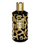 Perfume bottle with leopard print design on a white background