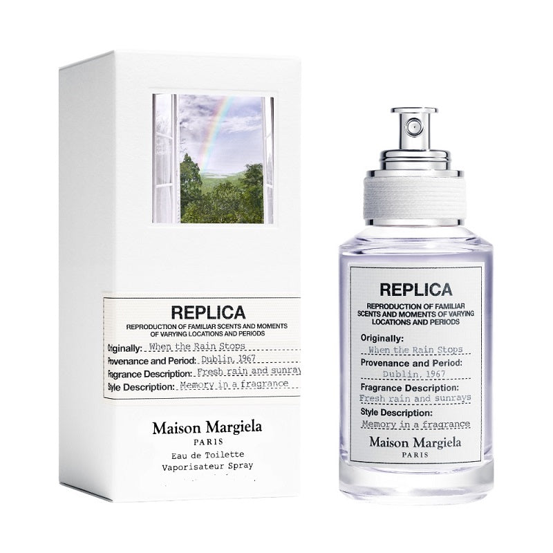 Maison Margiela Replica perfume bottle and its packaging box on a white background.”