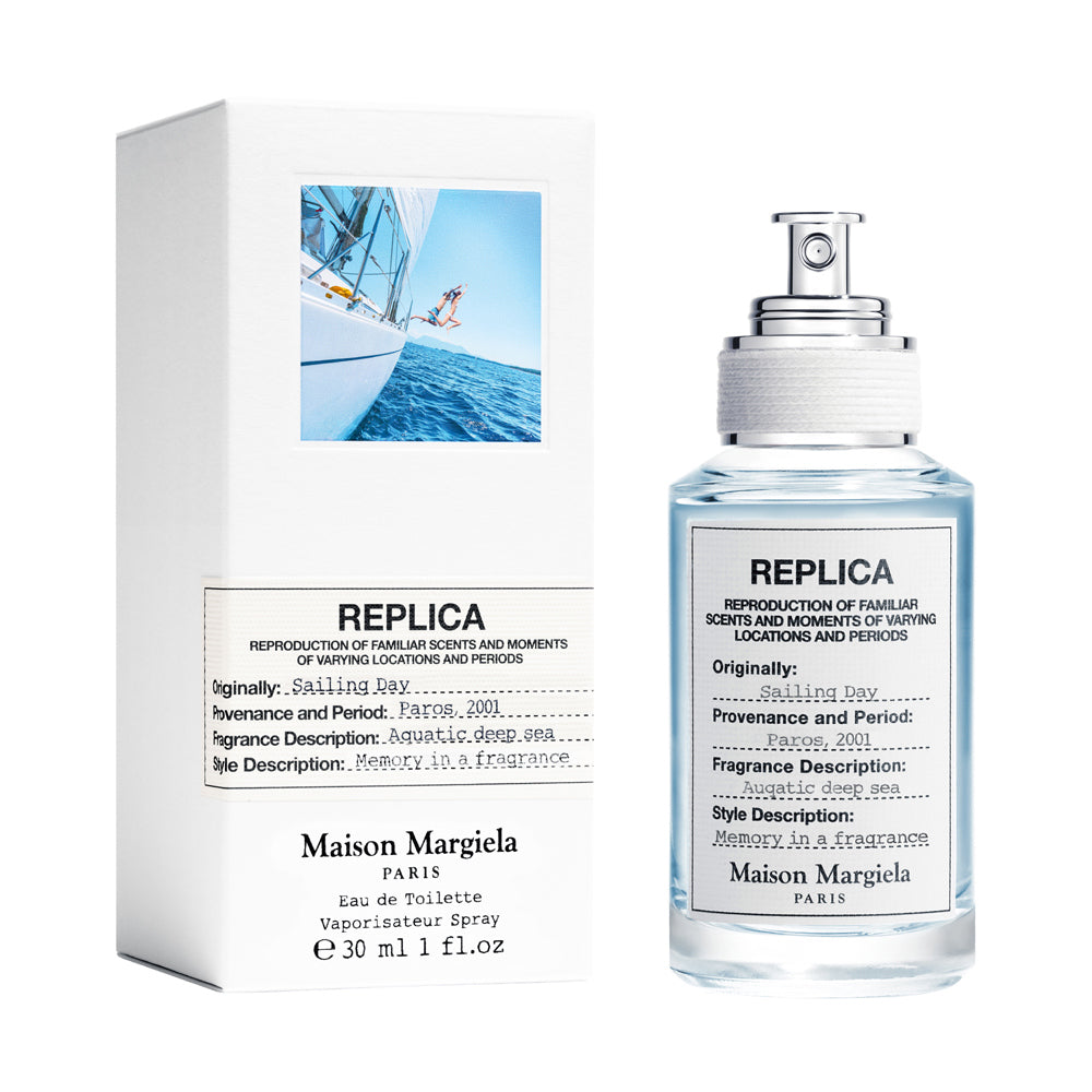 Maison Margiela Replica perfume bottle and its packaging box on a white background.