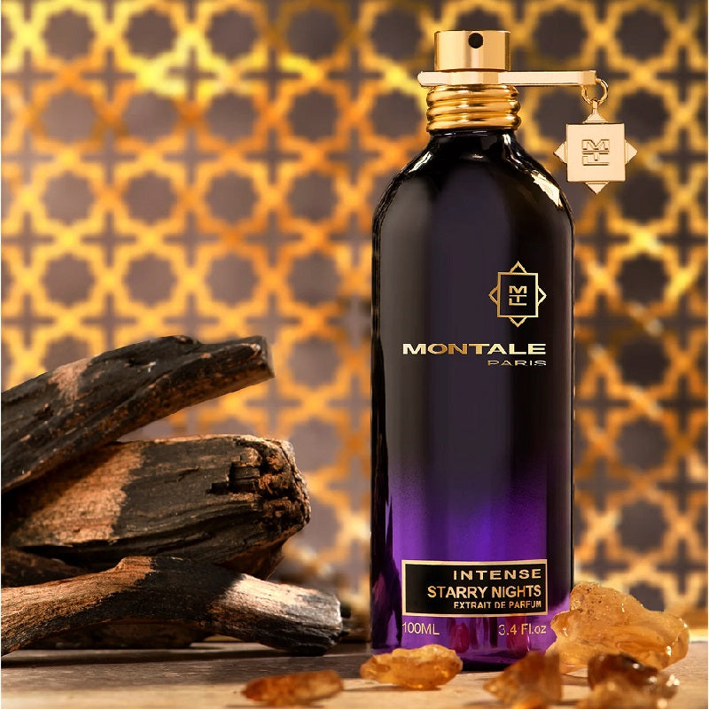 Montale Paris Intense Starry Nights perfume bottle with wooden logs and amber on a patterned background