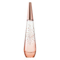 A spray bottle of 'Pure Petale De Nectar' Eau de Toilette by Issey Miyake, featuring a clear glass construction with rose gold accents and rose petal designs.