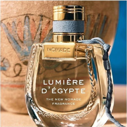 Perfume bottle labeled 'Lumère d'Egypte' with decorative elements on a textured background