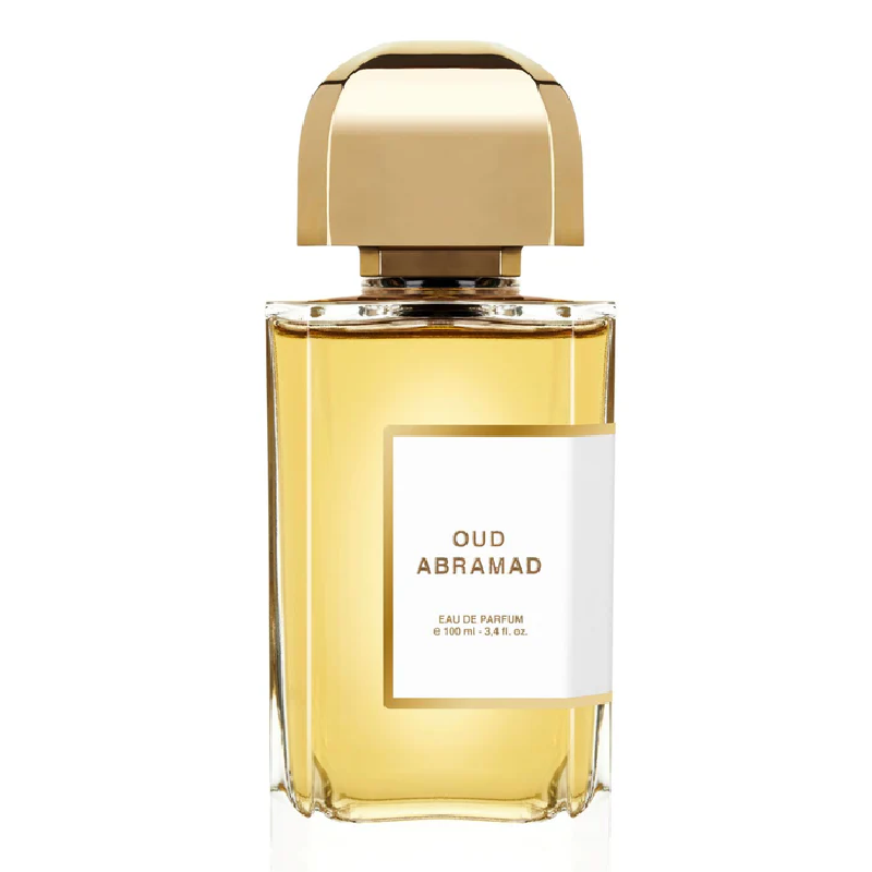 A bottle of 100ml Oud Abramad Eau de Parfum by BDK Parfums with a clear label, gold cap, and a yellow-tinted fragrance liquid.