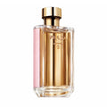 A glass bottle of Prada La Femme L'Eau Eau De Toilette with a gold cap and pink label.