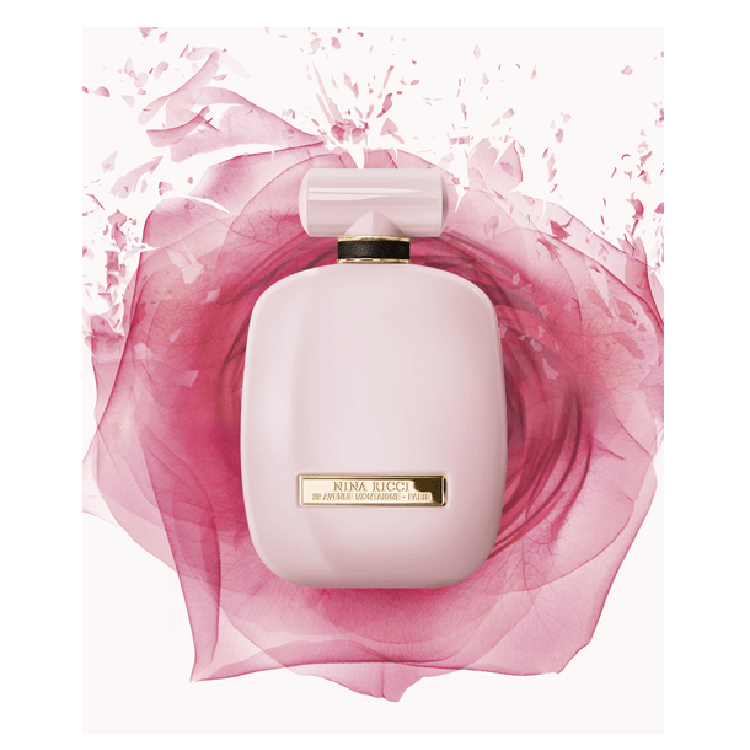 Pink perfume bottle with floral design on a white background