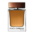 A glass bottle of Dolce & Gabbana 'The One' Eau de Toilette for men with a wooden cap.