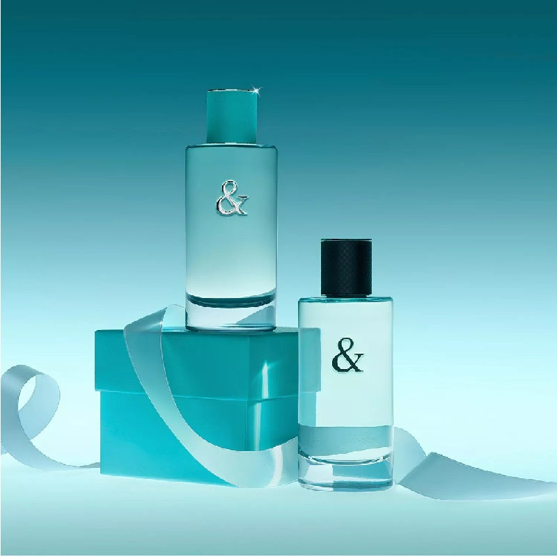 Two turquoise bottles with a '&' symbol on a light blue background