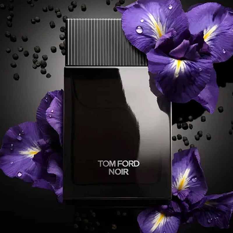 Tom Ford Noir perfume bottle surrounded by purple flowers on a dark background
