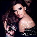 Lancème Tresor perfume advertisement with a model holding the perfume bottle.