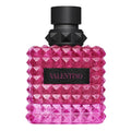 Pink diamond-patterned perfume bottle with black cap on a white background