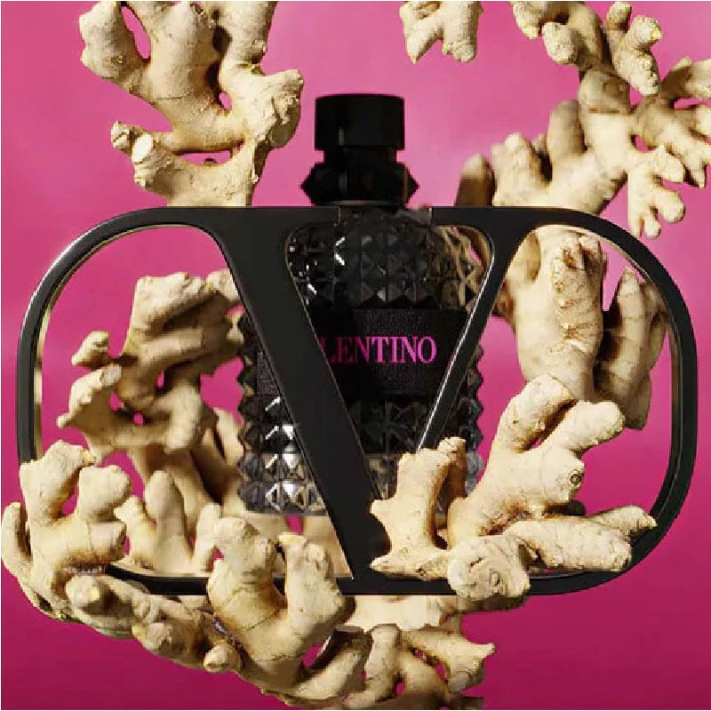 Valentino perfume bottle on a coral-like structure with a pink background
