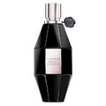 A black, hexagonal bottle of Flowerbomb Midnight Eau de Parfum by Viktor & Rolf with a clear label, silver accents, and a black cap.