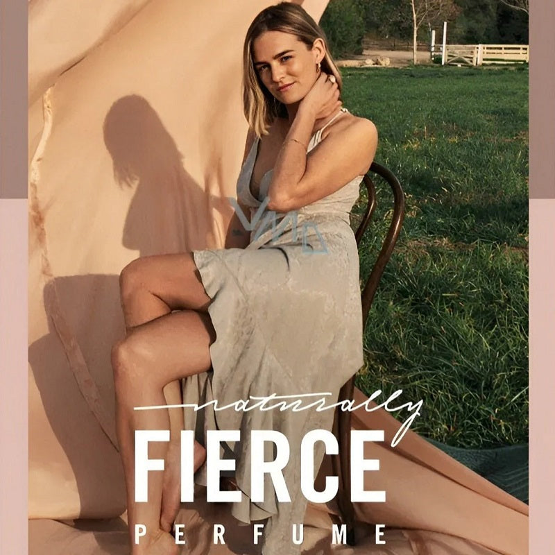 Woman sitting outdoors with 'naturally FIERCE PERFUME' text overlay
