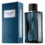 Abercrombie & Fitch First Instinct Blue Eau de Toilette shown with its blue ribbed box and the glass fragrance bottle on a white background.