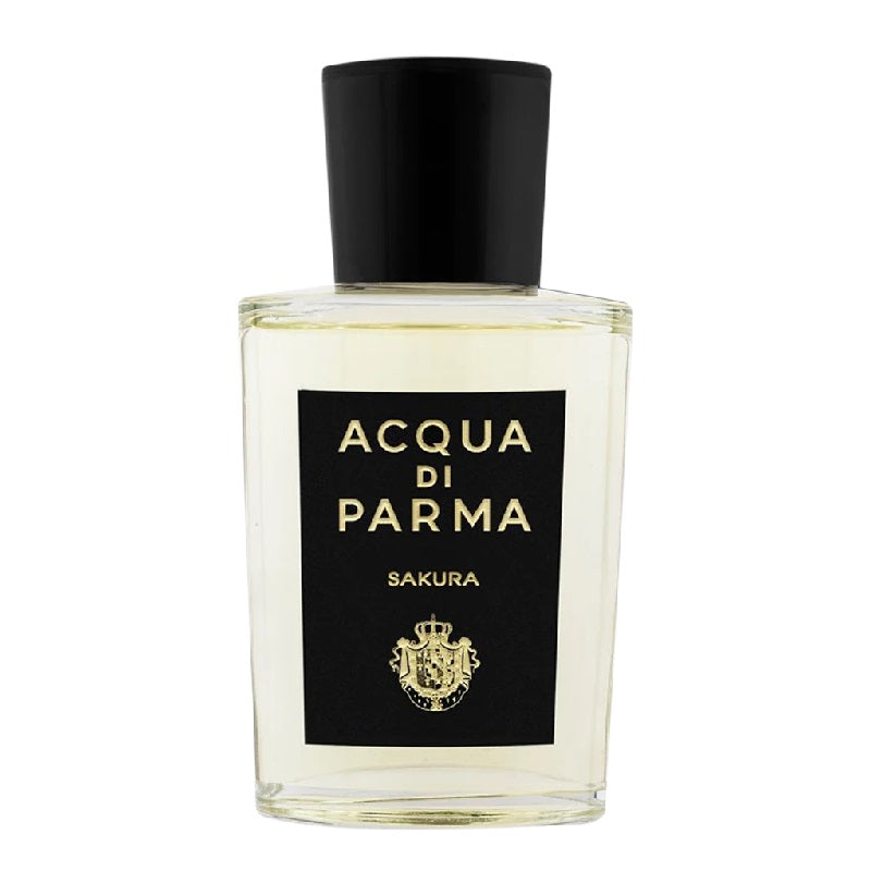 A clear glass bottle of Acqua Di Parma Sakura Eau de Parfum with a black cap and label.