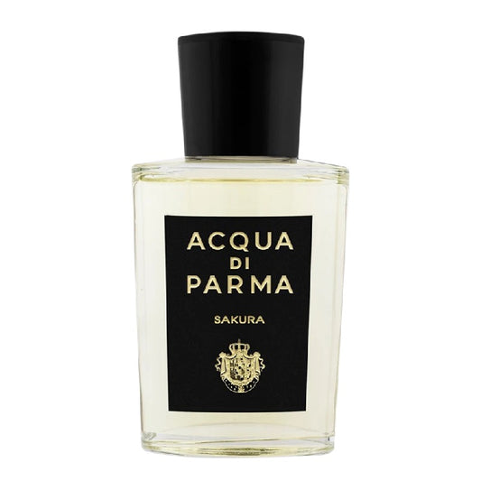 A clear glass bottle of Acqua Di Parma Sakura Eau de Parfum with a black cap and label.