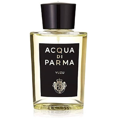 A clear glass bottle of Acqua Di Parma Yuzu Eau de Parfum with a black label and a gold and black cap.