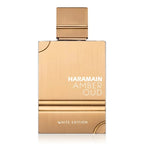 A bottle of Amber Oud White Edition eau de parfum by Al Haramain with a gold and white label on a white background.