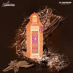 A pink colored bottle of Rose Oud Eau de Parfum by Al Haramain with a decorative cap and label, displayed against a white background.