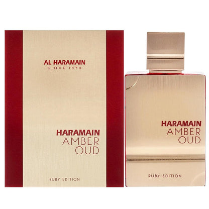 A product image featuring Al Haramain Amber Oud Ruby Edition Eau de Parfum in a clear glass bottle with a gold label, alongside its red and gold packaging box.