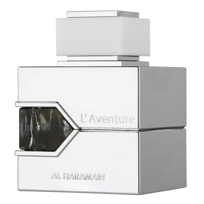 A bottle of L'Aventure Blanche Eau de Parfum by Al Haramain with a white and silver design, featuring a geometric shape and the brand name prominently displayed.