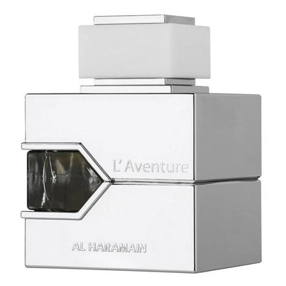 A bottle of L'Aventure Blanche Eau de Parfum by Al Haramain with a white and silver design, featuring a geometric shape and the brand name prominently displayed.