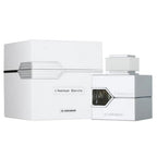 A bottle of L'Aventure Blanche eau de parfum by Al Haramain alongside its white packaging box.
