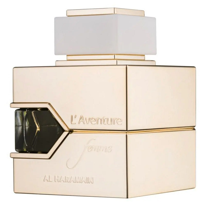A gold-colored bottle of L'Aventure Femme Eau de Parfum by Al Haramain with a white cap and label detailing the fragrance name and brand.