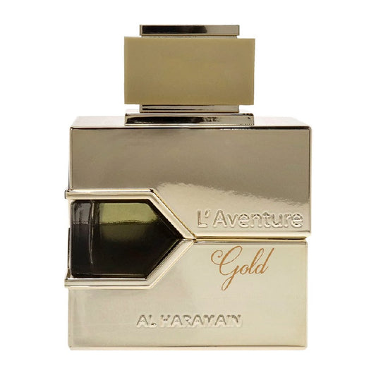 A square-shaped bottle of L'Aventure Gold Eau de Parfum by Al Haramain with a gold-colored cap and label.