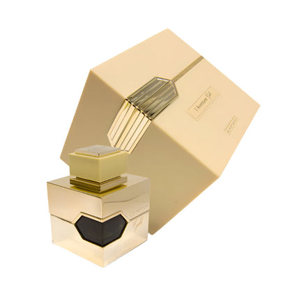 A gold-colored bottle of L'Aventure Gold Eau De Parfum by Al Haramain, with the cap on and the product box in the background.
