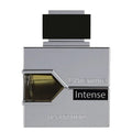 A square-shaped perfume bottle with a metallic finish and a label reading 'L'Aventure Intense'. The cap is black, and the visible liquid inside the bottle is brown.
