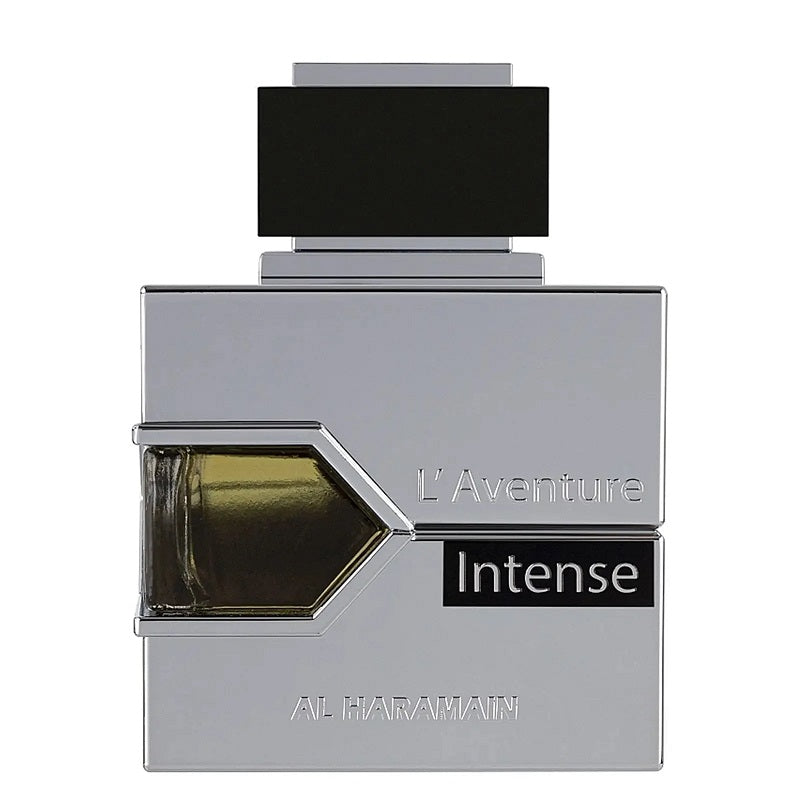A square-shaped perfume bottle with a metallic finish and a label reading 'L'Aventure Intense'. The cap is black, and the visible liquid inside the bottle is brown.