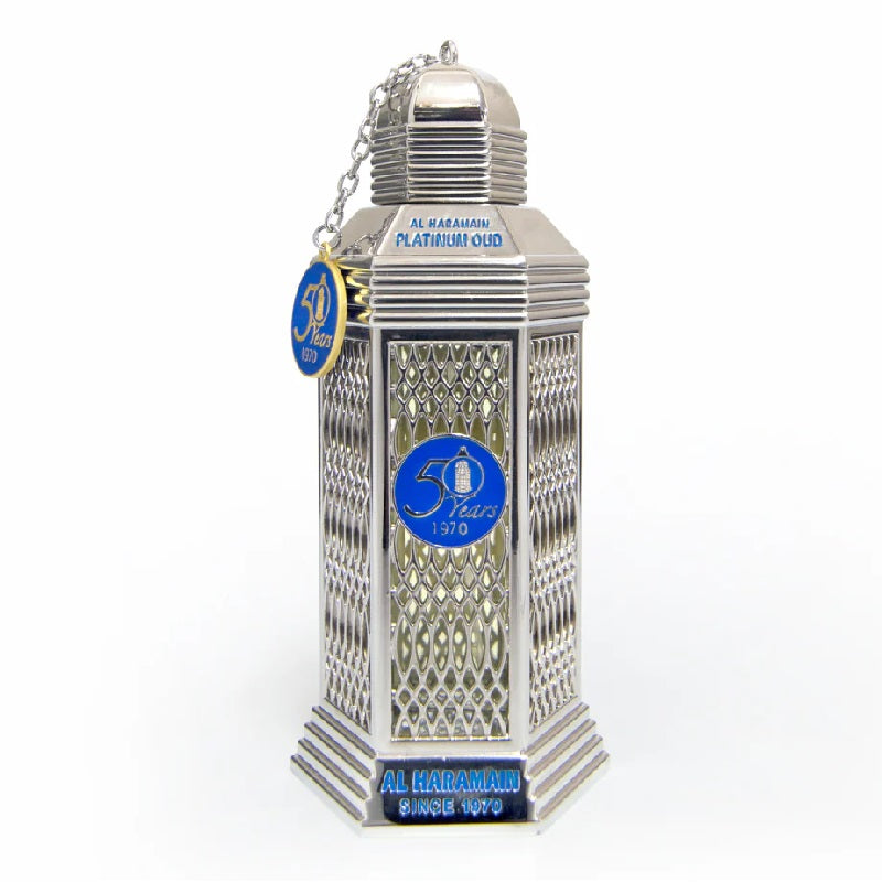 A silver-colored bottle of Platinum Oud Eau De Parfum by Al Haramain with a blue label and decorative elements.