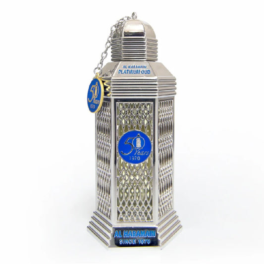 A silver-colored bottle of Platinum Oud Eau De Parfum by Al Haramain with a blue label and decorative elements.