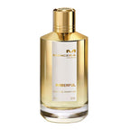 A bottle of Amberful Eau de Parfum by Mancera with a clear, golden liquid visible and a gold-colored cap. The label displays the product name and brand.