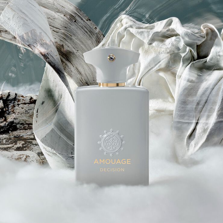 Amouage perfume bottle with natural elements in the background