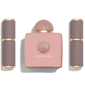 Amouage perfume set with pink bottle and gray containers on a white background
