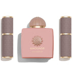 Amouage perfume set with pink bottle and gray containers on a white background