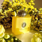 Close-up of Amouage Love Mimosa perfume bottle showing the floral-inspired cap and label