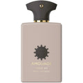 A beige-colored bottle of Opus XII Rose Incense perfume by Amouage with a black cap and gold detailing.