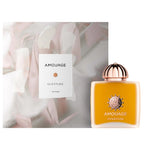 Amouage Overture perfume bottle and packaging with a soft floral background