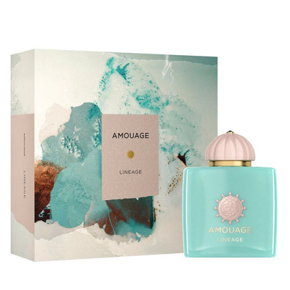 A product image featuring a 100ml bottle of Amouage Lineage Eau De Parfum with a turquoise liquid visible through the clear glass. The packaging is predominantly white with a artistic representation of a floral motif and the Amouage logo.