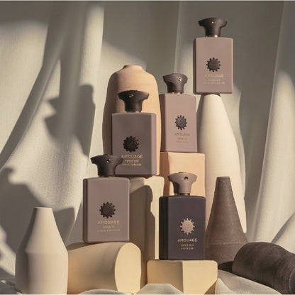 Close-up of Amouage Opus V Woods Symphony perfume bottle showcasing multiple Library Collection bottles.