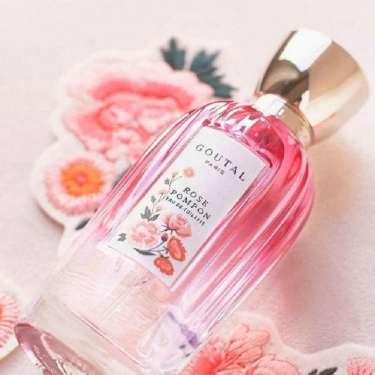 Goutal Rose Pompon perfume bottle with floral design on a light background