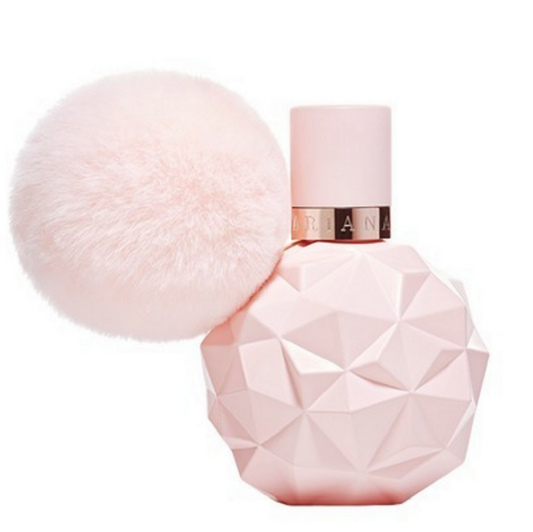 A bottle of 'Sweet Like Candy' Eau de Parfum by Ariana Grande with a geometric pink design, topped with a fluffy white cap.