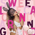 Person in lingerie with bunny ears and a perfume bottle against a colorful text background