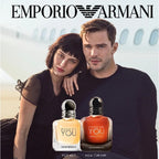 Boyfreind and Girlfreind standing behind 2 bottes of Because its you by Empoio Armani
