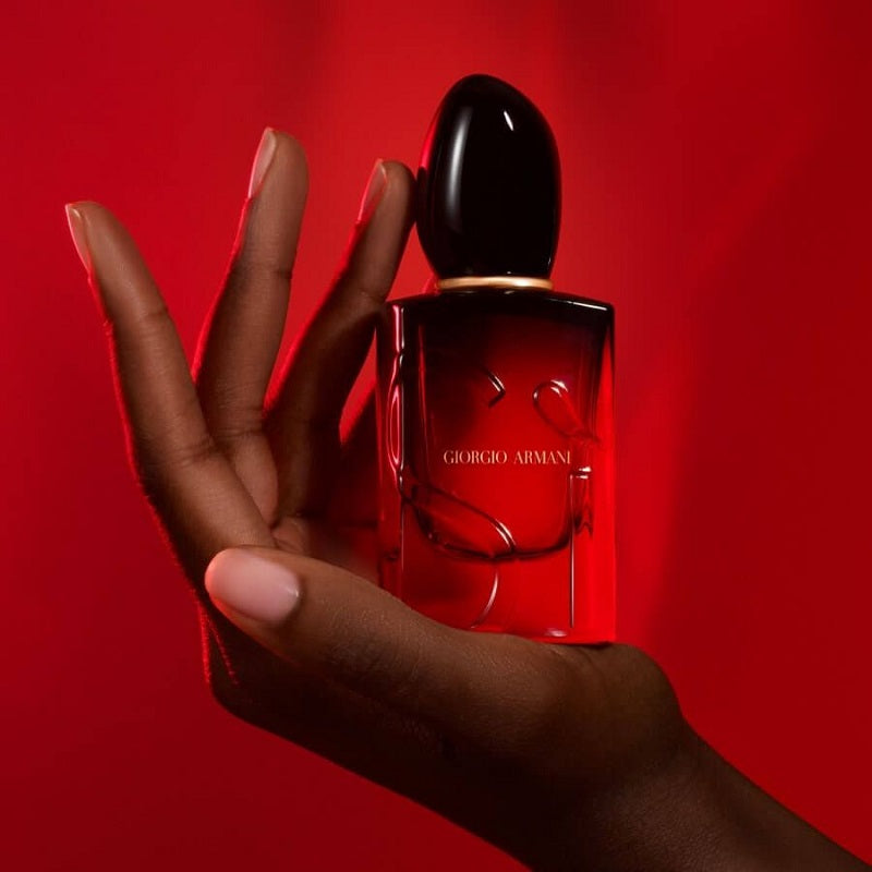 Giorgio Armani Si Passione Intense 50ml perfume displayed in a lifestyle scene with rich red and black accents.