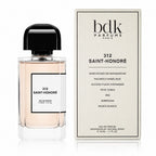 A bottle of Bdk Parfums Paris 312 Saint-Honoré Eau de Parfum next to its cream-colored packaging box, displayed on a clean white background with a subtle reflection.