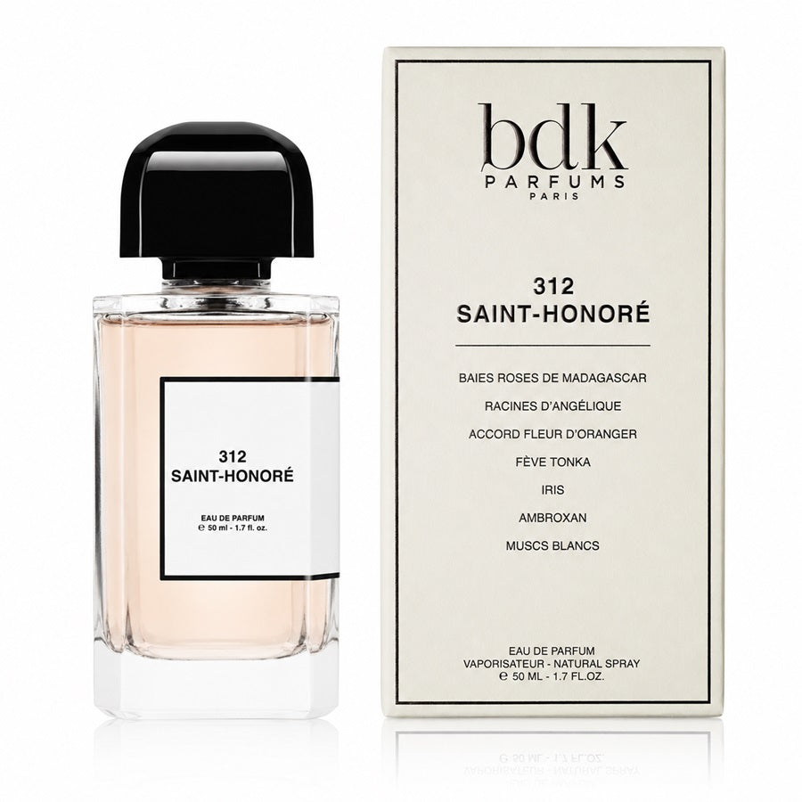 A bottle of Bdk Parfums Paris 312 Saint-Honoré Eau de Parfum next to its cream-colored packaging box, displayed on a clean white background with a subtle reflection.
